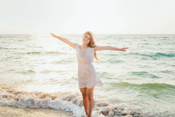 istock female enjoying the sun on beach 639829364