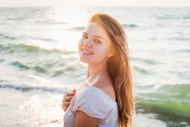 istock female enjoying the sun on beach 639829426