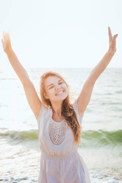 istock female enjoying the sun on beach 639830630