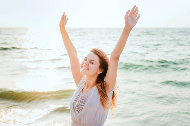 istock female enjoying the sun on beach 639830720