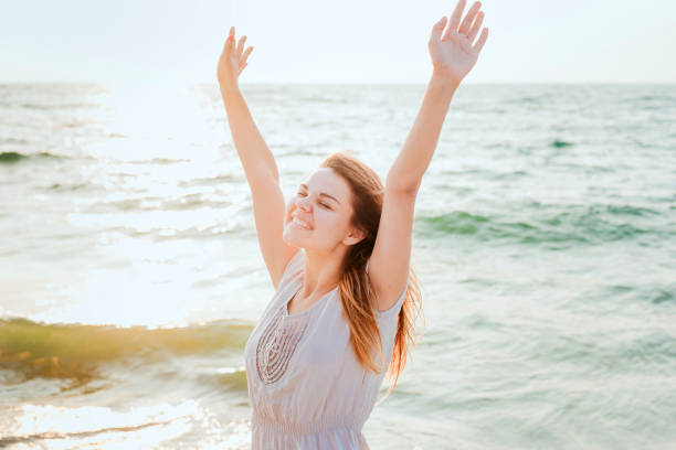 istock female enjoying the sun on beach 639830752