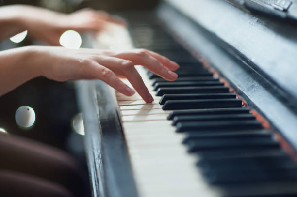 istock Hands on an old antique piano. Close-up 639830980