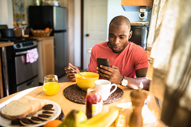istock african guy doing breakfast at home 639831066