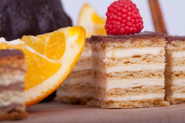 Very tasty chocolate cake  with orange on a wooden base, selective focus and small depth of field