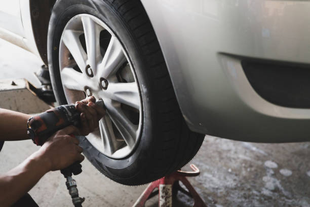 istock Auto mechanic in his workshop changing tires or rims 639832328