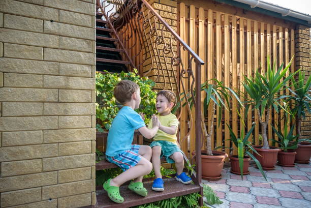 istock Two adorable little brothers laughing and hugging each other on 639832990