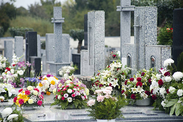 istock Crosses, flower bouquets, tombstones in a graveyard. 639833964