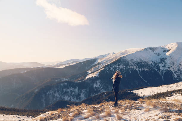 istock Young woman admiring mountain landscape 639834144