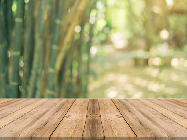 istock Wooden board empty table over blur in bamboo forest 639836040