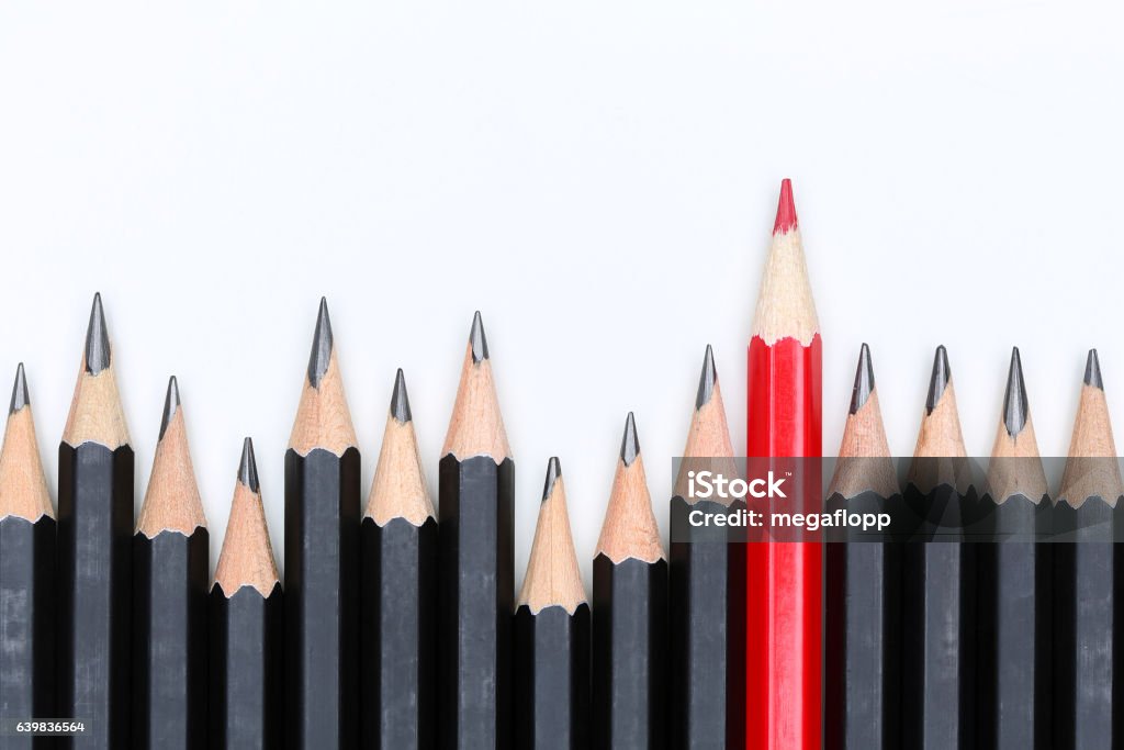 Red pencil standing out from crowd of plenty identical fellows Red pencil standing out from crowd of plenty identical black fellows on white background. Leadership, uniqueness, independence, initiative, strategy, dissent, think different, business success concept Standing Out From The Crowd Stock Photo