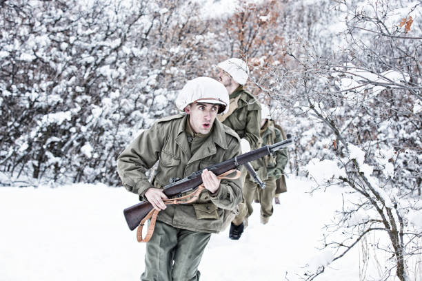 istock Four WWII US Infantry Soldiers Out On Wintry Patrol 639837430