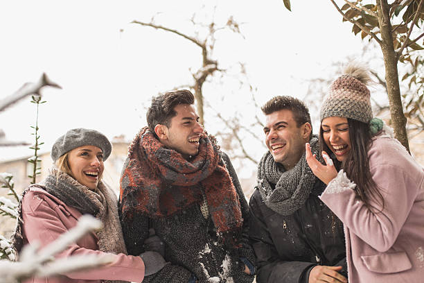 istock Friends laughing in snowy park 639838886