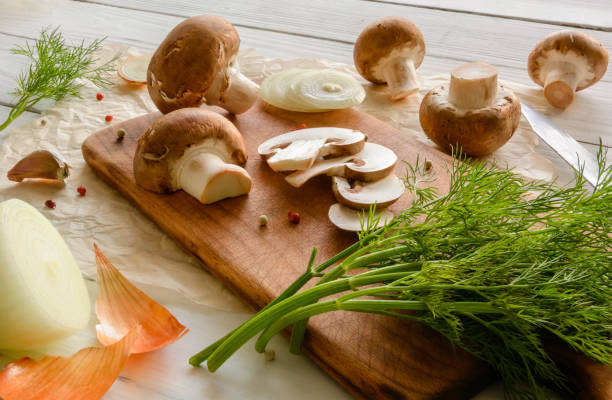 istock Brown champignon mushrooms on a cutting board. 639841048