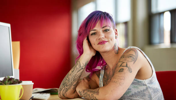 istock Confident female designer working in red creative office space 639841832