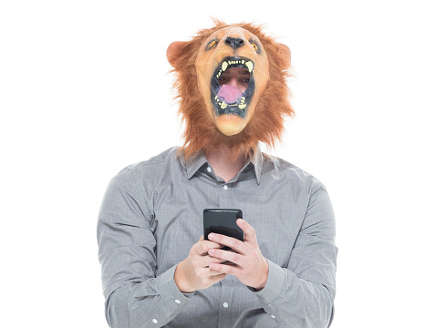 Man in lion costume and using phone