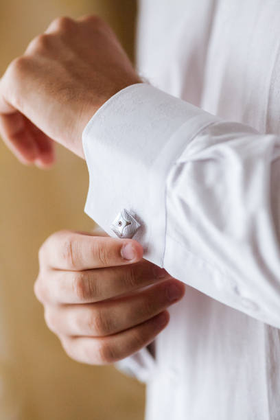 istock the man corrects cuff links on a shirt. the groom 639844970