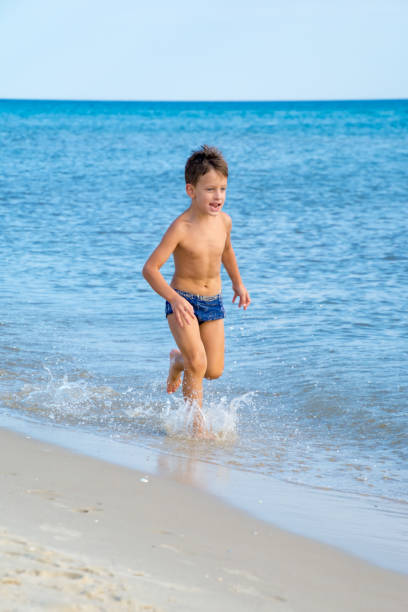 istock Six year old boy playing on beach 639846674