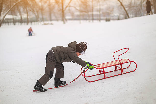 istock Little boy pushing sleds 639846722