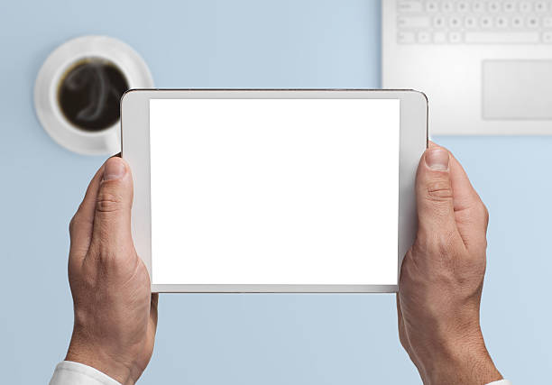 istock Man hipster holding tablet knolling overhead view 639848556