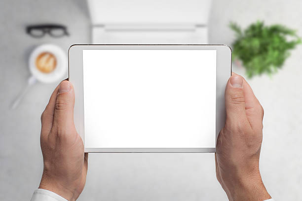 Man hipster holding tablet knolling overhead view
