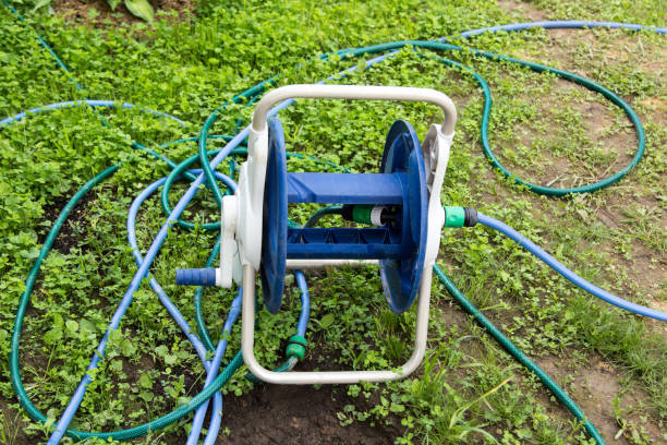 istock tangled garden hose with a reel on grass 639849594