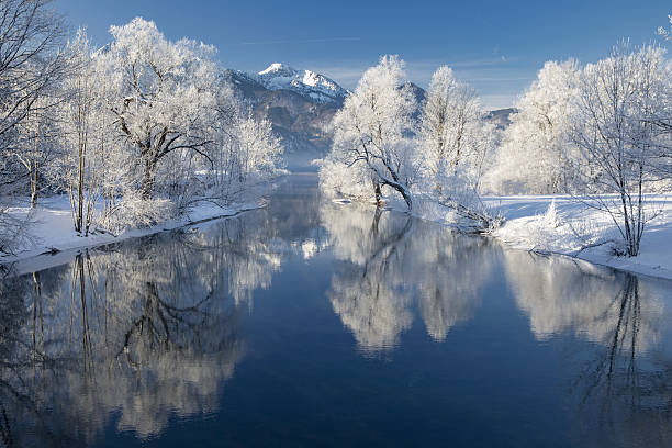River Loisach entering Lake Kochel in Winter - Bavarian Alps River Loisach flows into the Kochelsee, winter with rime and snow on the trees snow river stock pictures, royalty-free photos & images