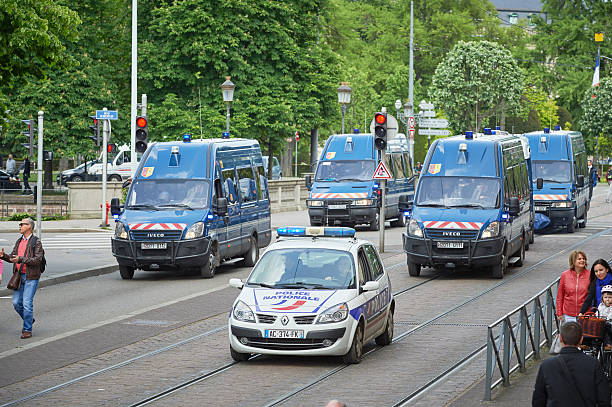 Police vans at protest Paris, France - May 19, 2016: Elevated view of row of police vans surveilling protest against proposed French government's labor and employment law reform riot police stock pictures, royalty-free photos & images