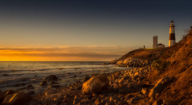 Montauk Lighthouse During Sunrise Montauk Lighthouse resting on the edge of the coast during the golden sunrise. montauk point stock pictures, royalty-free photos & images