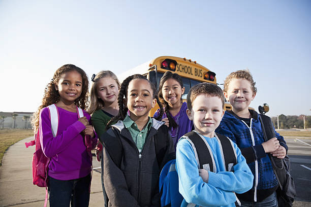 istock Children standing outside school bus 639858208