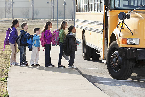 istock Children boarding school bus 639858244