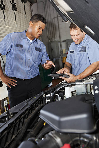 auto mechanics in garage with digital tablet - sc0573 imagens e fotografias de stock