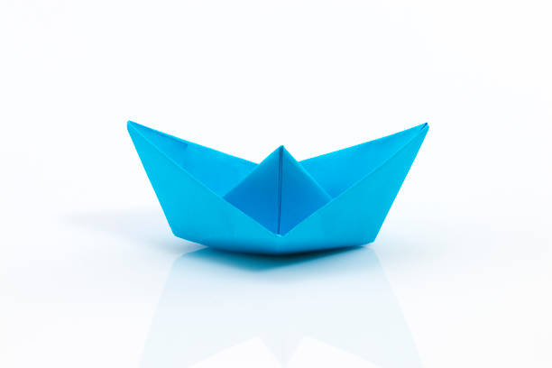 istock Close up origami ship isolated on white background 639859410