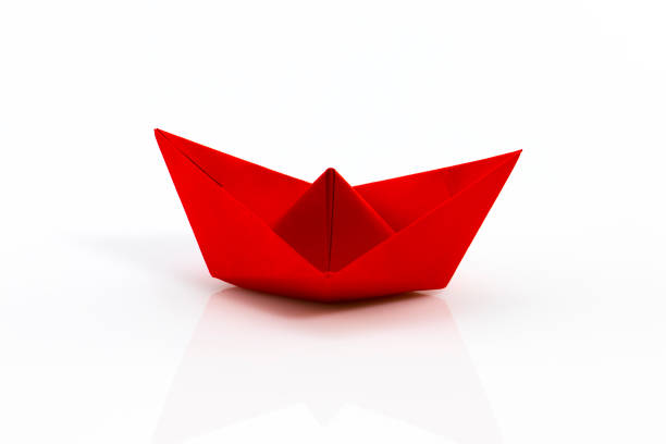 istock Close up origami ship isolated on white background 639859448