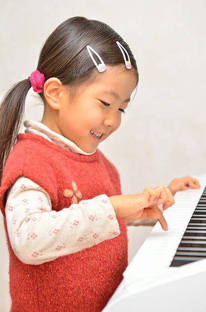 istock Japanese girl playing piano 639859532