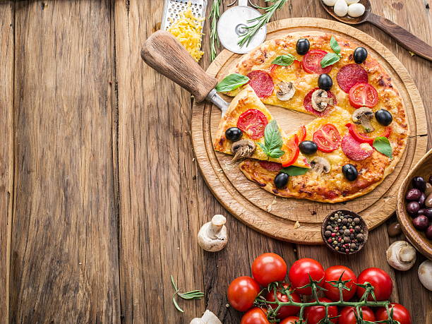 istock Pizza with mushrooms, salami and tomatoes. 639860416