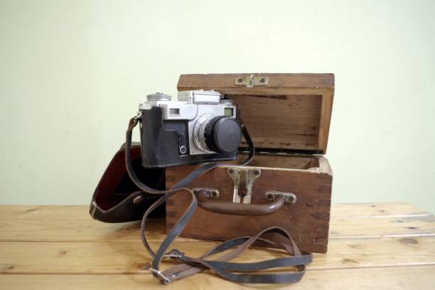 photo of retro, analog camera on wooden box
