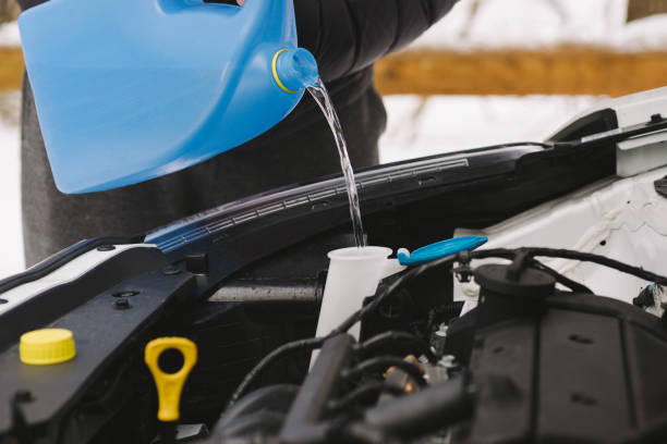 Man Pouring Car Winter Windshield Washer Fluid Stock Photo - Download Image  Now - Windshield Wiper Fluid, Backgrounds, Adult - iStock