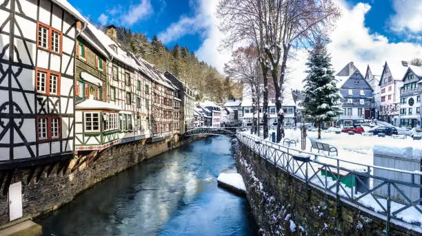 Timbered House row in a fairy tale winter scene. Historical village Monschau near the recreation area Eifel. Beautiful winter day