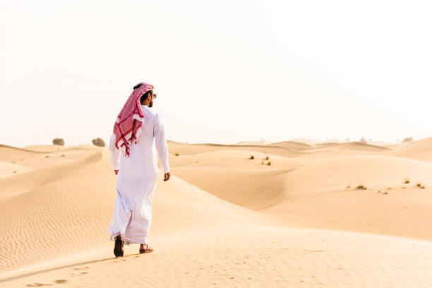 istock arabic sheik walking on the desert 639863550