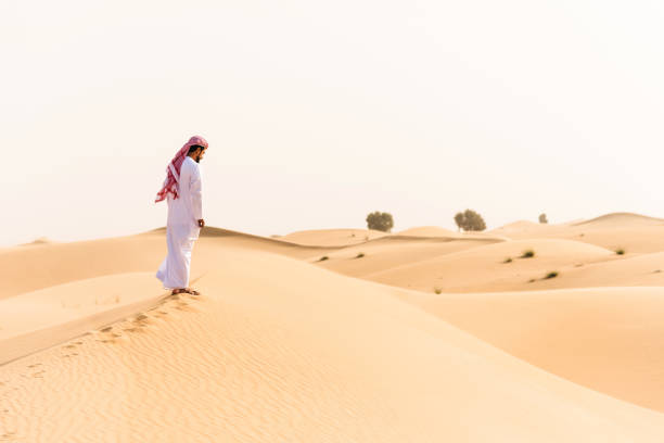 istock arabic sheik walking on the desert 639863634