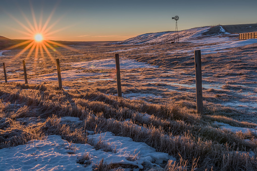 winter sunrise on a prairie coulee (also known as a gully, a ravine, a gulch, or a small valley, a ditch, a draw, or a coolie)