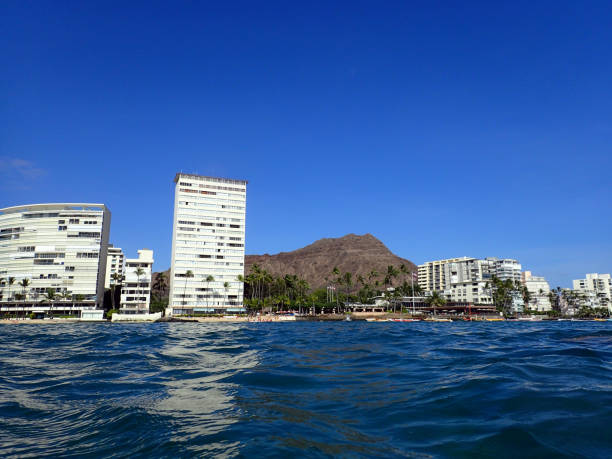 istock Wavy water on ocean off Kaimana Beach with hotels 639864408