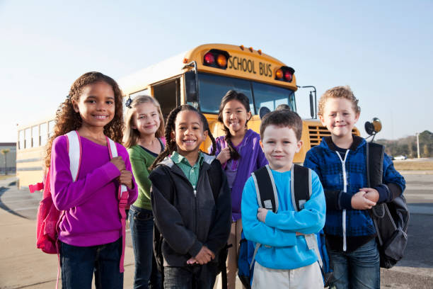 istock Children standing outside school bus 639865686
