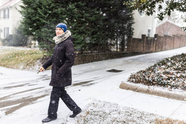 istock Man with car keys walking in coat during winter snow 639866346