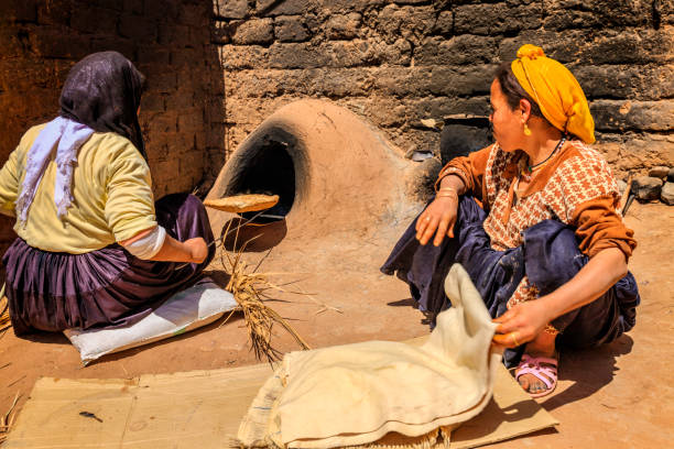 istock Moroccan women baking bread - khubz 639866390
