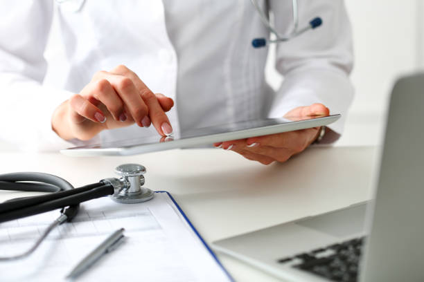 Female doctor hold digital tablet pc Female doctor hold digital tablet pc and point in touch screen with finger closeup. Human interaction, professional consultation, therapeutist examine test results, new search opportunities concept medical insurance data stock pictures, royalty-free photos & images