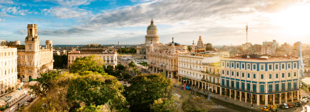 Panoramic Skyline of Old Havana Cuba Panoramic image of Old Havana skyline at sunset, Cuba cuba stock pictures, royalty-free photos & images