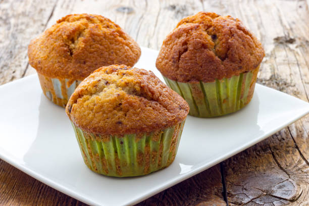 istock Muffins on a wooden table 639868304