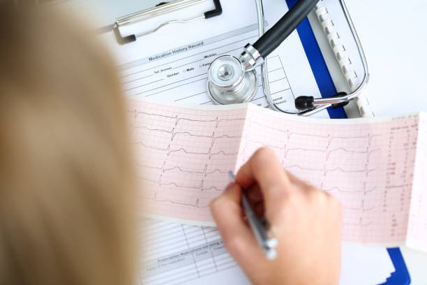 istock Doctor hands with cardiogram chart on clipboard pad 639868846