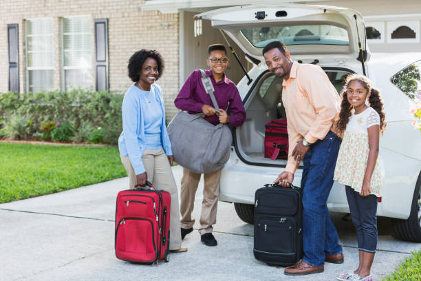 istock Family loading luggage into car going on vacation 639870492
